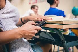Student hiding use of smartphone in class