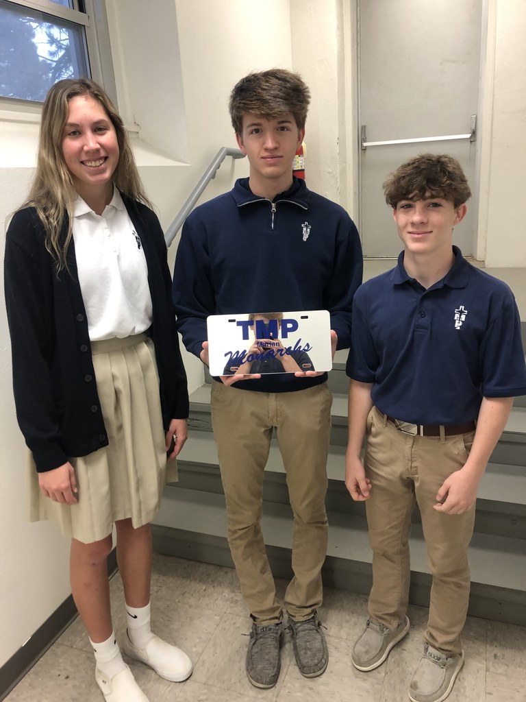 Emilee and Gavin present Ethan with his Monarch license plate.