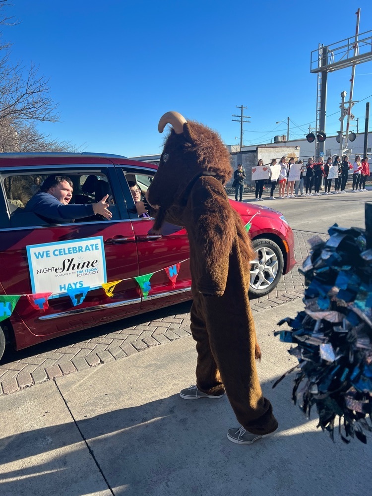 TMP-M Mascot gives high five to prom attendee as they paraded down Main Street 