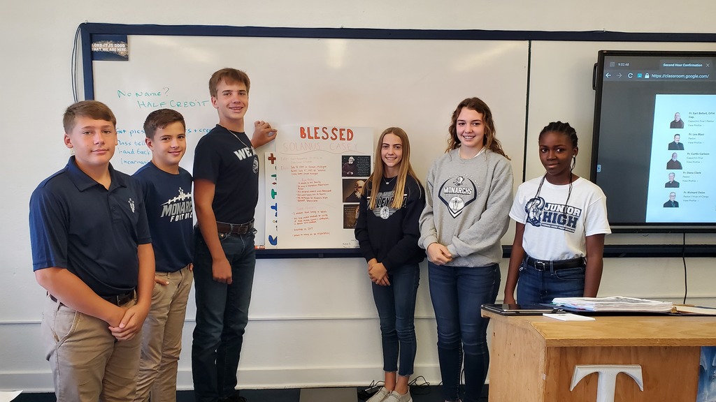 Students display their poster they created about Blessed Solanus Casey.