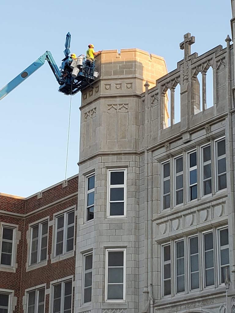 worker on a lift doing exterior masonry work